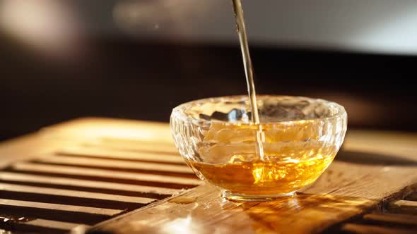 Tea Poured Into Glass Background Smoke Scented Sticks Backlit By Warm Light