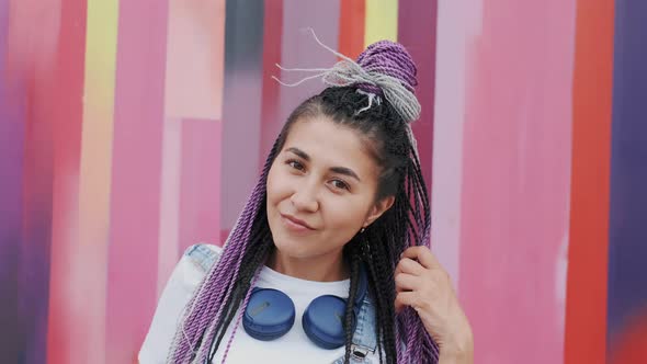 Portrait of Beautiful Trendy 20s Girl with Dreadlocks Looking At Camera and Smile