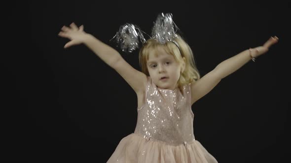 Happy Beautiful Little Baby Girl in Glossy Dress. Christmas. Make Faces, Dance