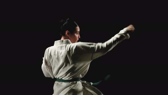 Young Woman in Kimono Practicing Karate