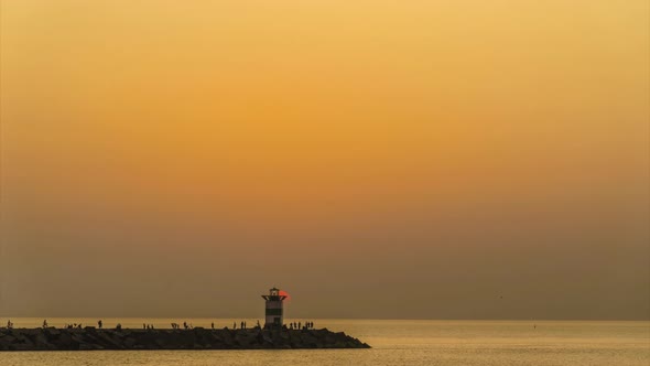 Sunset on the lighthouse of Scheveningen harbor at the summer hottest day ever