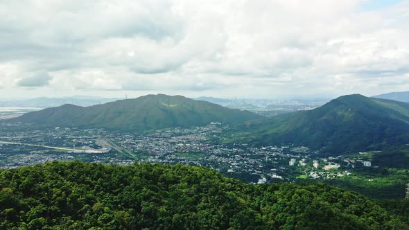 A dynamic onward aerial footage from the mountains and reveals the cityscape of Kam Tin in Hong Kong