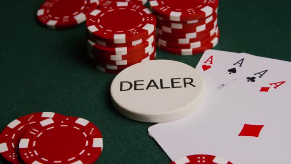 Rotating shot of poker cards and poker chips on a green felt surface - POKER 002