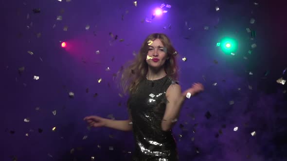 Girl in Brilliant Dress Dancing Under Glitter Confetti. Slow Motion