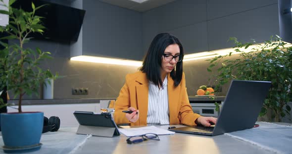 Woman in Business Clothes Sitting in front of Computer and Working 