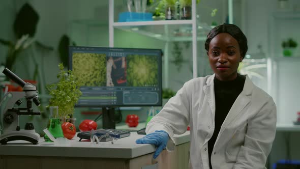 Pov of African Woman Sitting at Desk Table in Pharmaceutical Laboratory