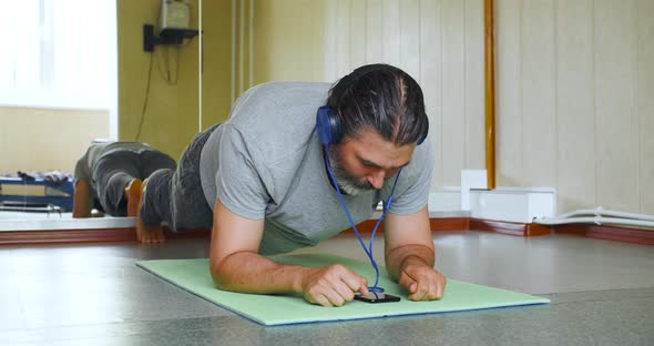 Closeup View of a Middle Aged Man During Plank Workout