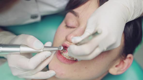 Professional dentist working with patient at dental office.