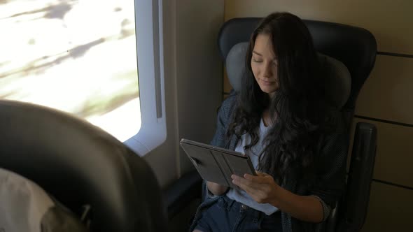 Woman With Tablet in Train