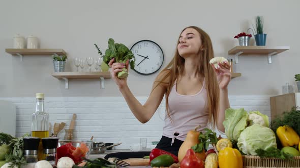 Girl Recommending Eating Raw Vegetable Food. Showing Broccoli and Cauliflower. Weight Loss, Diet