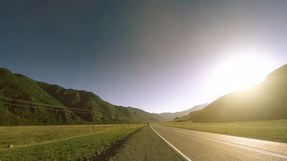 Mountain Road Timelapse at the Summer or Autumn Sunset Sunrise Time. Wild Nature and Rural Field