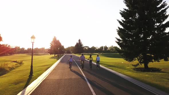 Group of Young Persons Riding Bicycles Outdoors