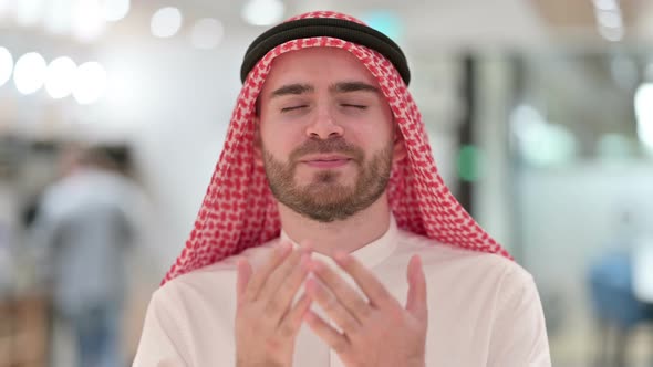 Portrait of Religious Young Arab Businessman Praying