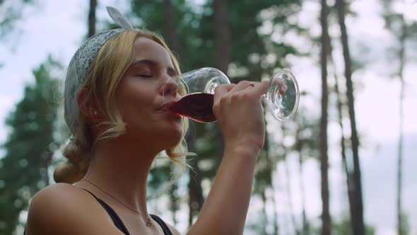 Young Woman Drinking Wine Outdoors