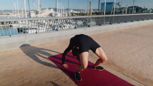 Flexible Woman Doing Wheel Pose on Embankment