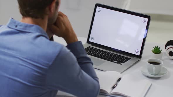 Caucasian businessman having video call meeting using laptop