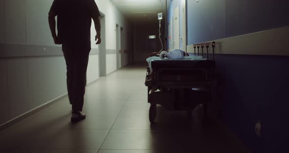 A Hospital Gurney Left After Urgent Patient Stands in Hospital Corridor