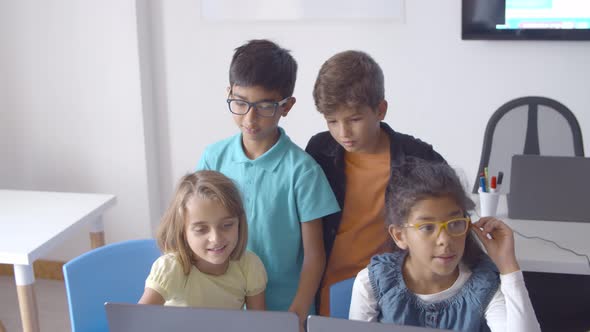 School Boys and Girls Sitting and Standing at Desk