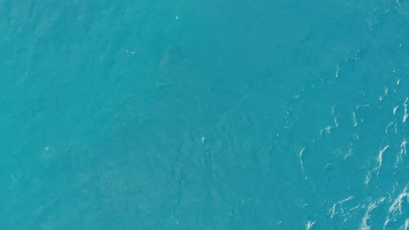 Blue sea surface seen from above, water texture of ocean, aerial