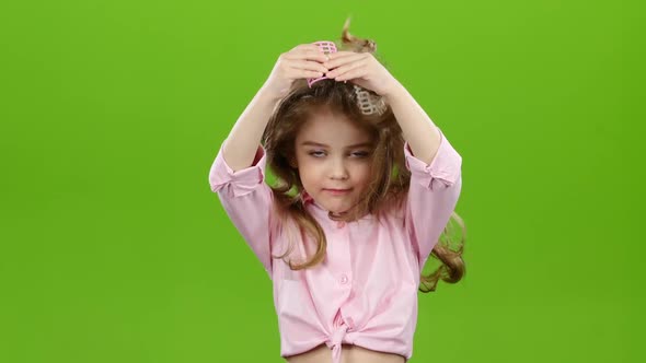 Child with Curlers on His Head, Removes Curlers. Green Screen