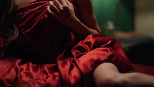 Unknown Woman Covering Red Silk Sheet Bedroom. Unrecognizable Girl Relaxing Bed.