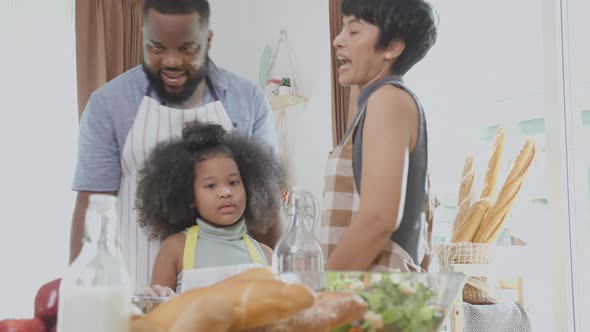 African America family wearing apron thresh flour for cooking and dancing and song together.