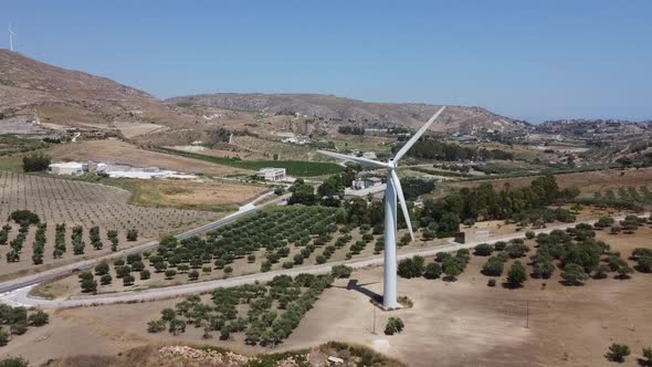 Wind Turbines In A Wind Farm With Olive Groves Growing In The Field On A Sunny Day In Agrigento, Sic