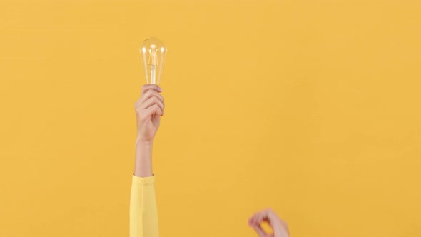 Woman hand doing finger snapping to turn on light bulb for creative and idea generation concepts