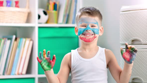 A Smiling Preschooler is Learning How to Draw at Home