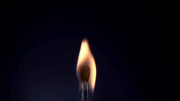 Match Lighting and Burning on Black Background. Slow Motion