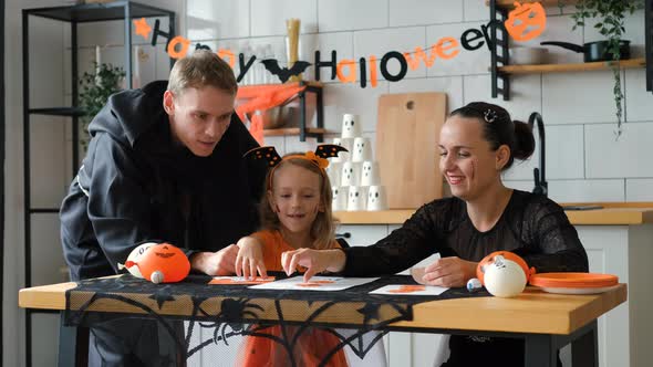 Family Playing DIY Halloween TicTacToe Game