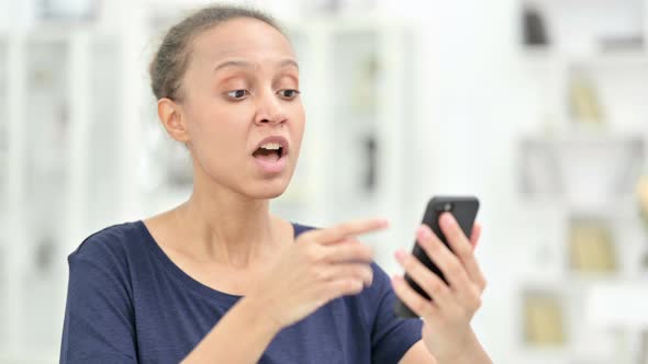 Portrait of African Woman Having Loss on Smartphone 