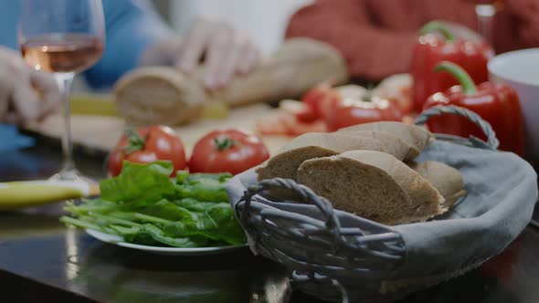 Woman hand preparing fresh salad at home.