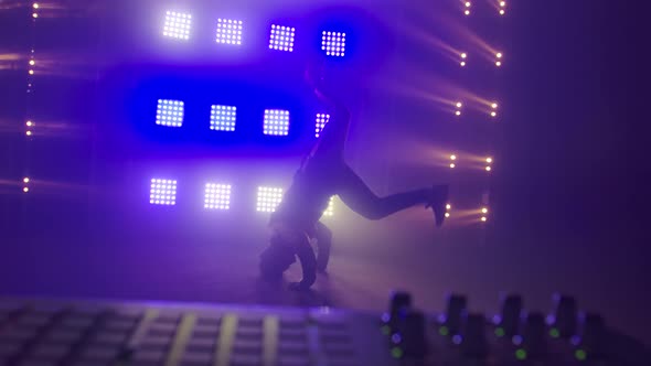 Breakdance Concept. Trendy Young Man Dancing Single in Club, Neon Light, Lots of Smoke. Fashion