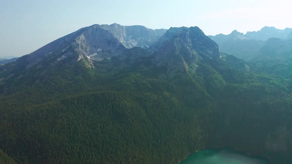 Dramatic mountains and black lake landscape in Durmitor, Montenegro. Aerial drone view