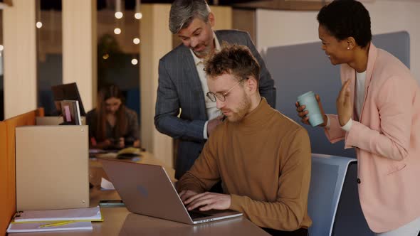 Multiethnic Business Team People Brainstorming Using Laptop Computer at Workplace