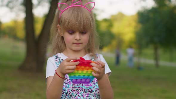 Child Girl Kid Playing Squeezing Antistress Pop It Touch Screen Toys Simple Dimple Game in Park
