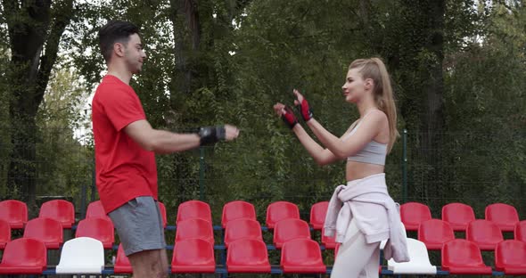 Man And Woman On The Sports Field Greet Each Other With Their Hands