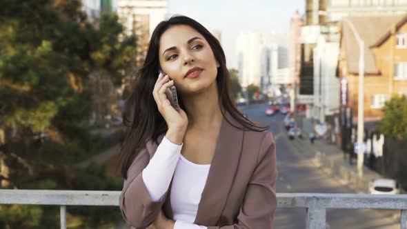 Beautiful Brunette Businesswoman In Business Clothes Walks In The City