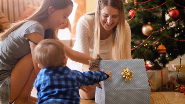 Footage of Happy Family Opens Christmas Gifts and Presents