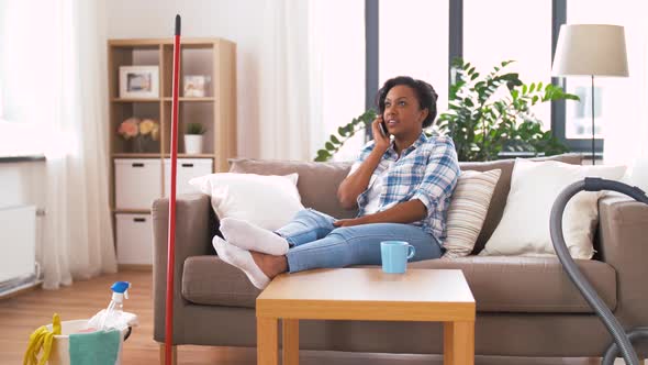 Woman Calling on Smartphone After Home Cleaning