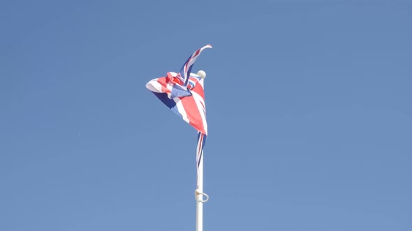 Slow motion of Union Jack  flag waving against blue sky 1920X1080 HD footage - Famous United Kingdom