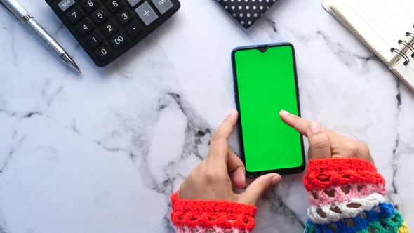 Top View of Women Hand Using Smart Phone with Stationary on Table