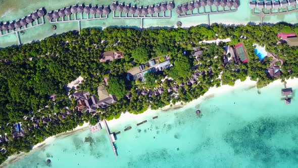 Wide angle panorama of lagoon beach by blue ocean with sand background near resort