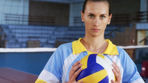 Female player holding volleyball in the court 4k