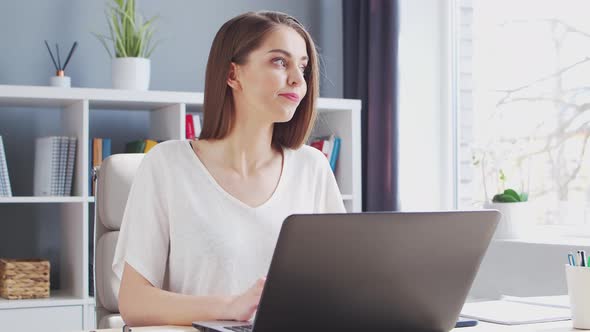 Young Woman Works at Home Office Using Computer.