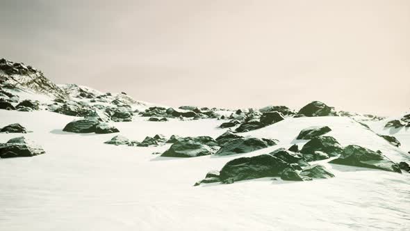 Snowy Mountains and Dark Rocks