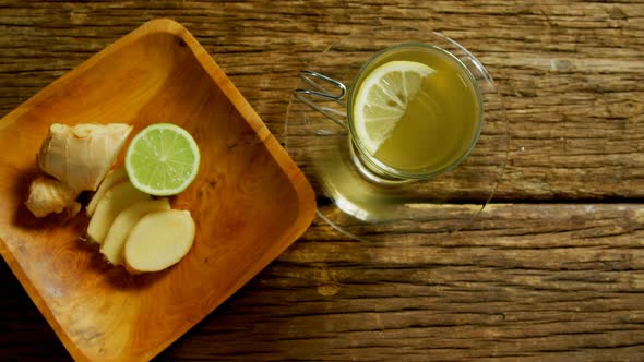 Lemon tea with ginger and lemon on wooden table 4k