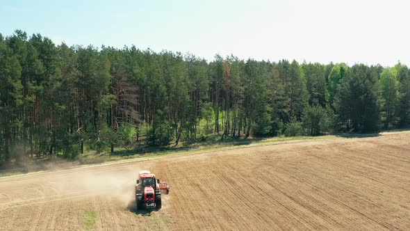 Elevated View Tractor With Seed Drill Machine Sowing The Seeds For Crops In Spring Season