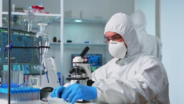 Scientist Ppe Suit Placing Slide Specimen Stage